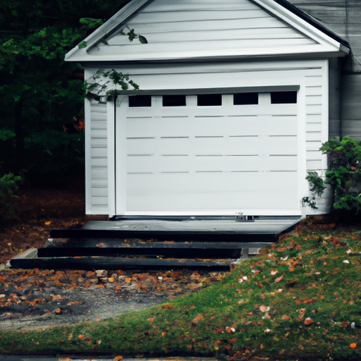 Suburban Wayland home with a white raised-panel garage door on a wet autumn day.